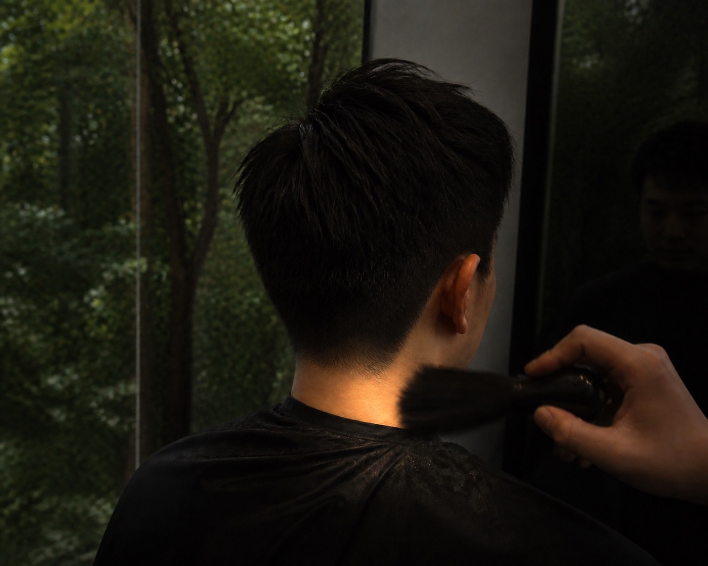 A men's haircut being finished at the chair at MANE Hair Experience, Far East Plaza Singapore